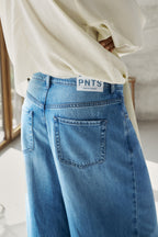 Detailansicht: Man sieht die hinteren Hosentaschen der Jeans 14_THE GENT in hellblau. 